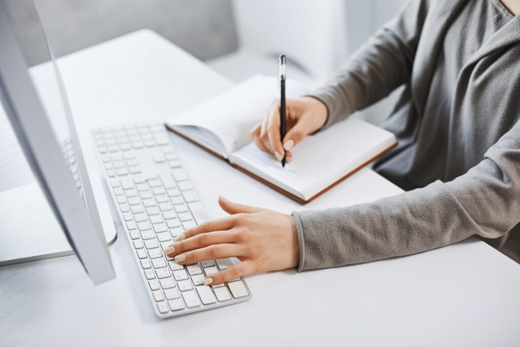 i can handle multi tasks cropped shot successful girl typing keyboard making notes while looking computer screen studying new business graphic there is no time rest scaled.jpg